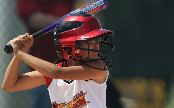 A female softball player at bat