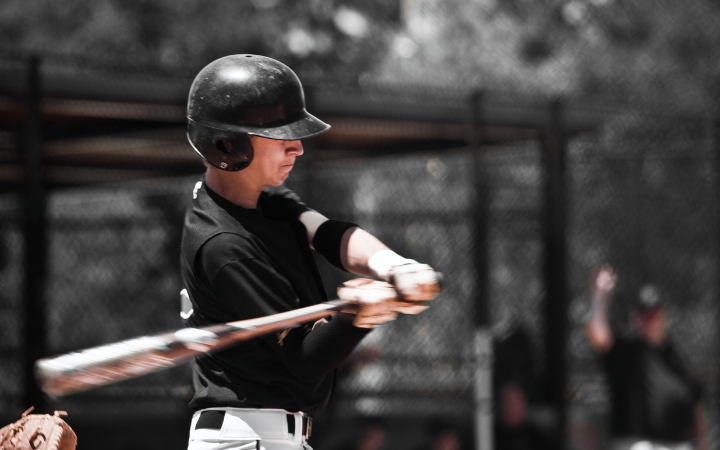 A teen baseball player up to bat