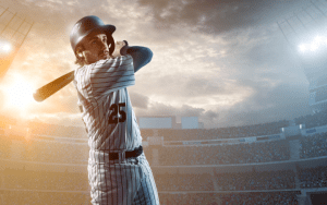 A batter swinging outdoors