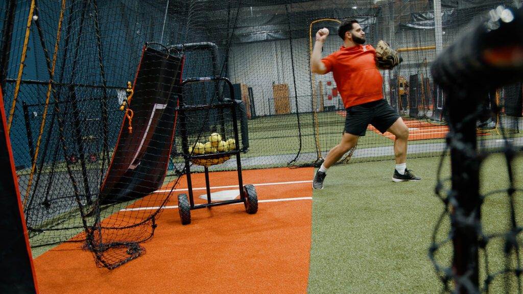 Coach Dato is showing how to throw a baseball