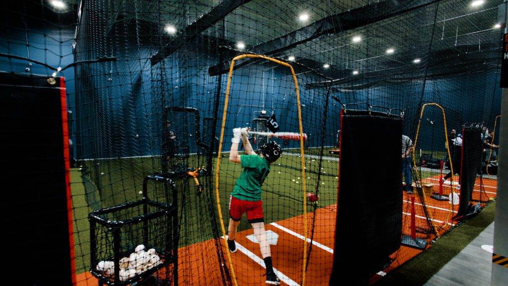 A player just swung his bat inside the batting cage
