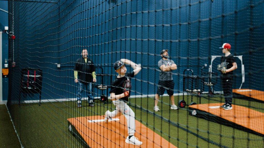 A young baseball player is practicing pitching