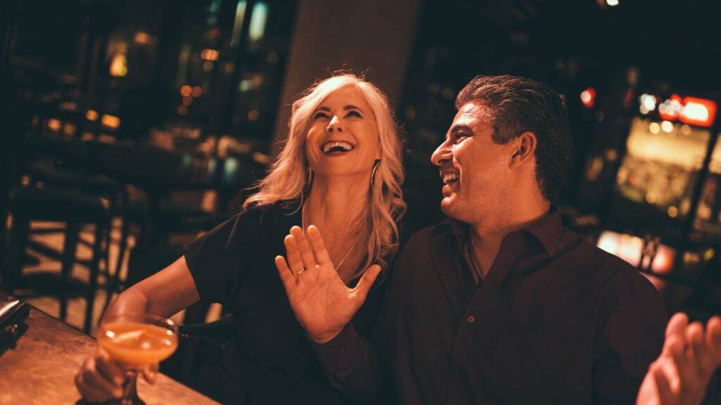 A man and woman enjoying drinks at a bar